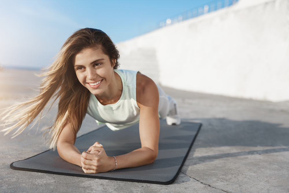 Woman smiling in a plank position