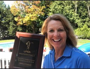 Debbie holding her LPGA Professional Award