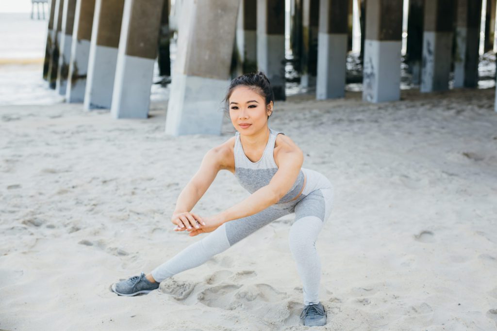 A woman is doing side squats