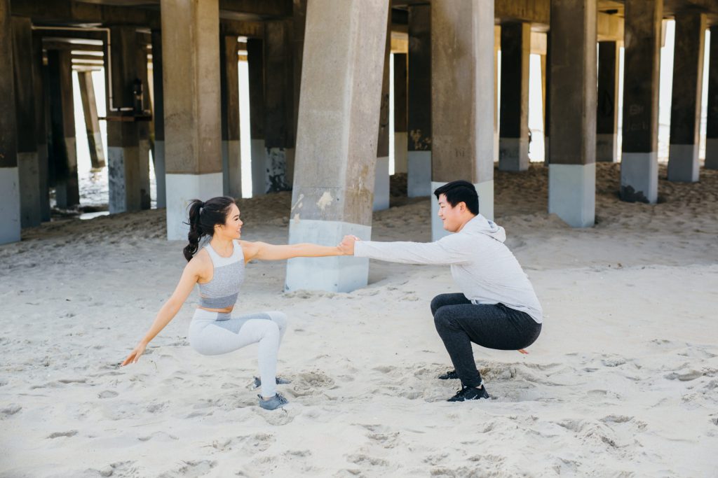 A couple is doing squats