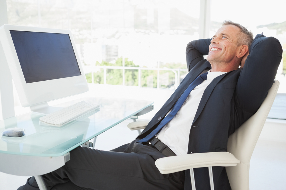 A happy business man enjoying his time at work in a beautiful modern office