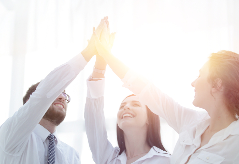 successful business team giving each other a high five.