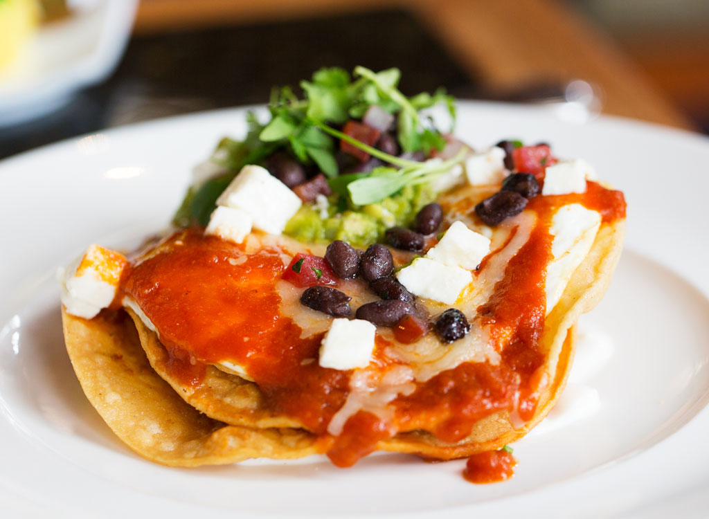 Huevos rancheros with black beans on a plate