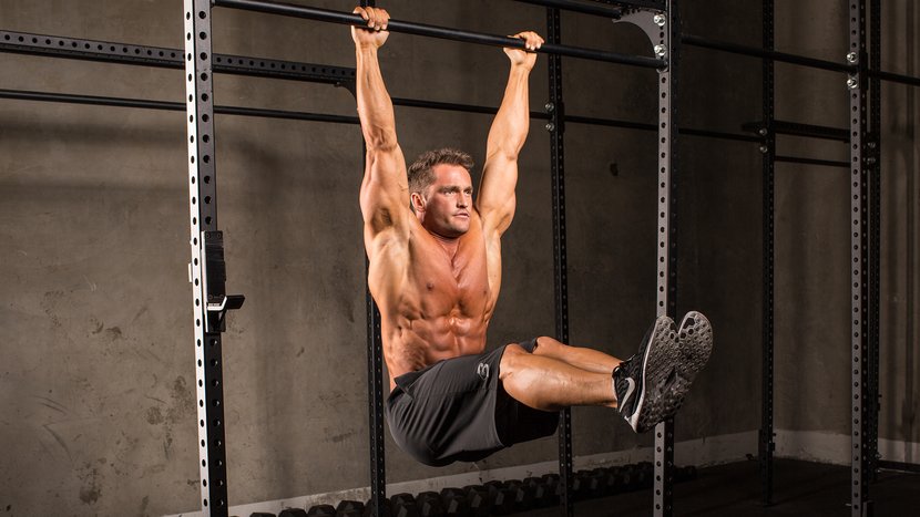 A man is hanging from a bar