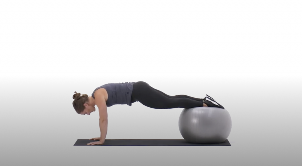 Woman doing a pike on an exercise ball