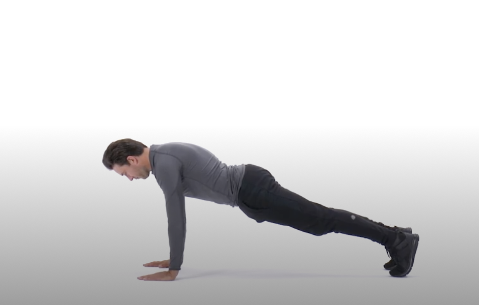 a man doing a plank on the floor