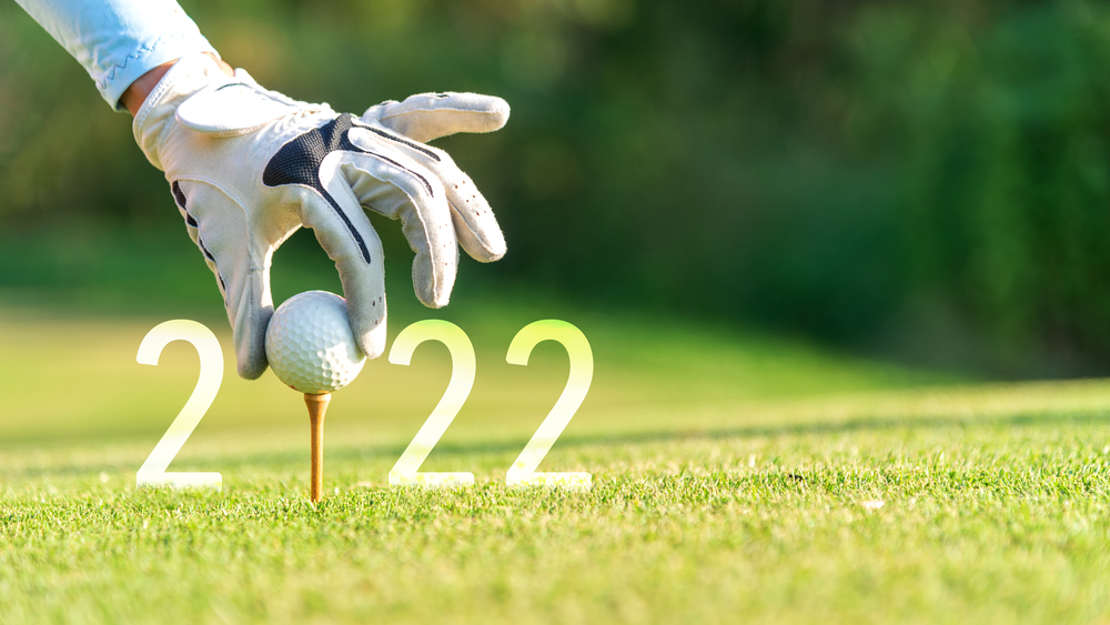 Close up hand 2022 with a golf ball on a tee for the "0".