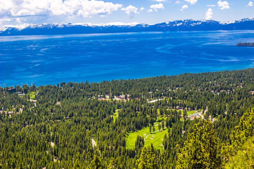 View looking down on Lake Tahoe and the golf course with the mountain backdrop