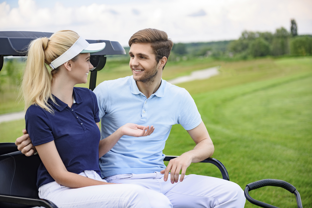 Attractive golfing couple talking