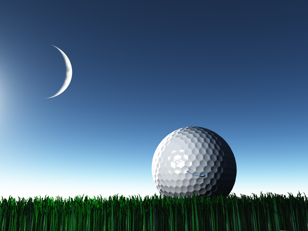 A golf ball on the green at night