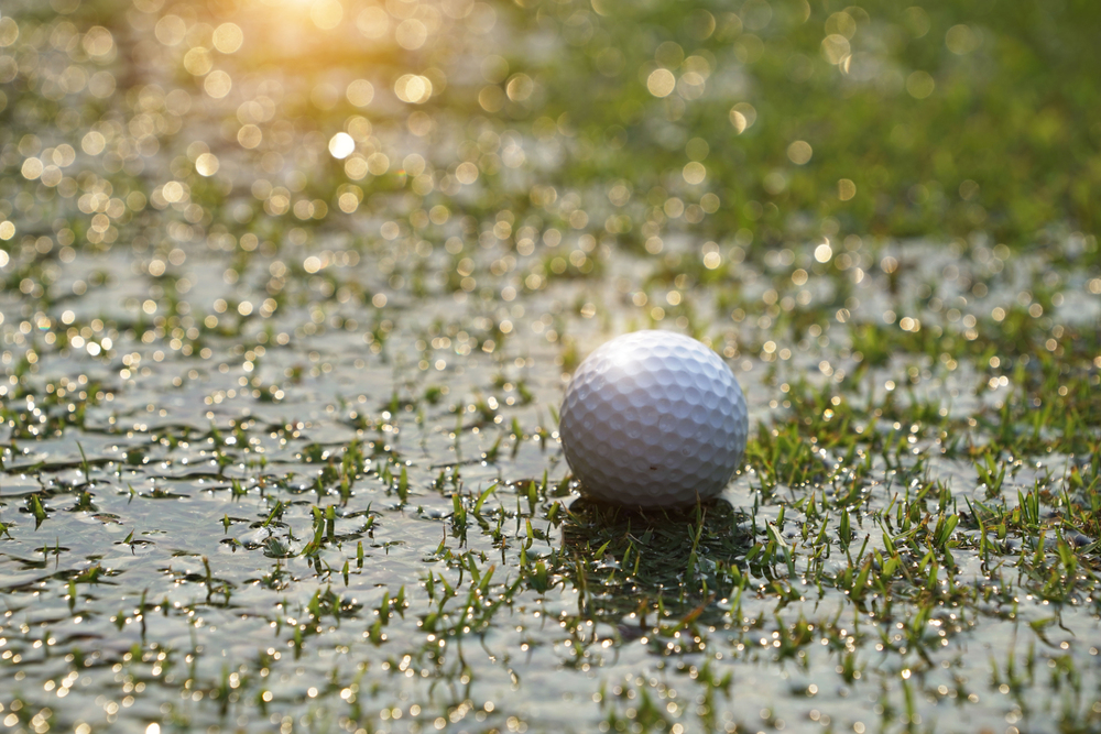 Focused golfer preparing to make the next shot